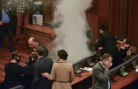 Tear gas is released during a session of parliament in Pristina, Kosovo February 26, 2016. REUTERS/Agron Beqiri