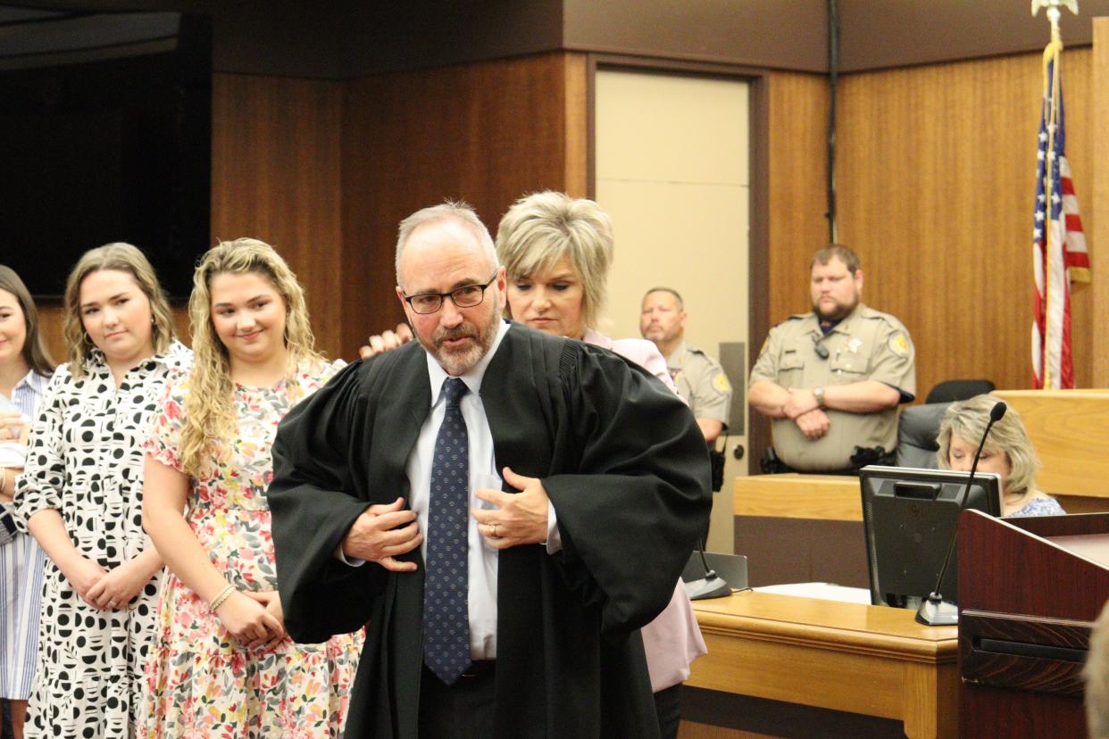 Ninth Judicial District Court Judge Loren Lampert adjusts his robe with the help of his wife, Lisa Lampert, on Wednesday morning during his investiture.