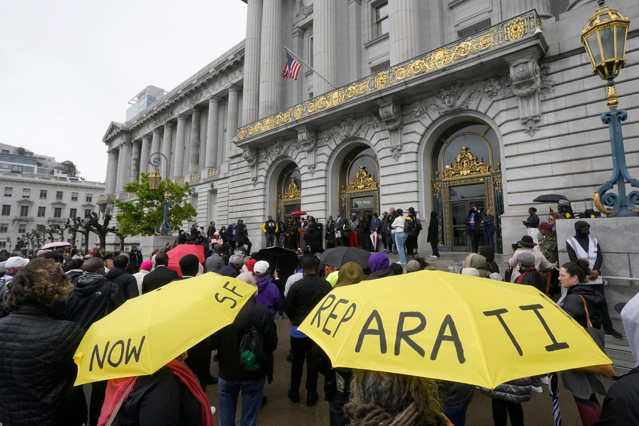 A crowd stands outside San Francisco City Hall to listen to speakers at a reparations rally on March 14th, 2023. California's task force estimates the state owes Black residents at least $800 billion in economic harms.