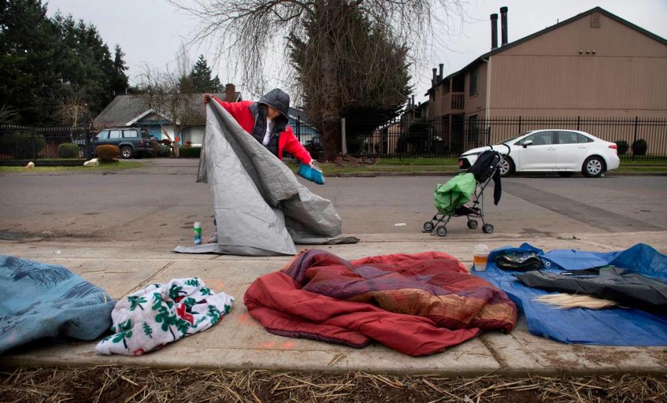 Lethecia Lee packs up her tent and belongings in anticipation of a forced move from the homeless encampment where she has stayed for the past three months on I Street and East 72nd Avenue in southeast Tacoma on Wednesday, Jan. 26, 2022.