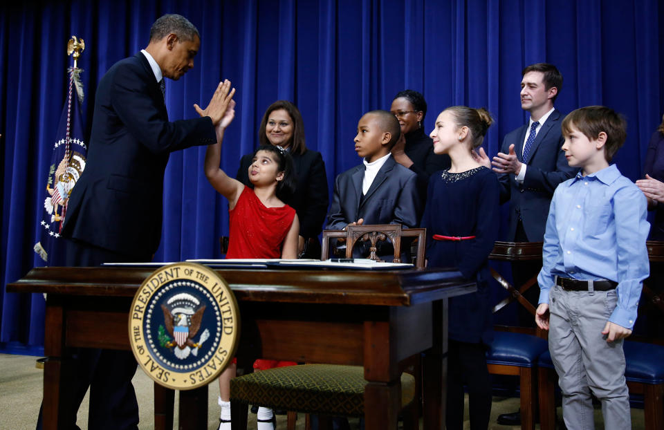 <p>President Barack Obama high-fives eight-year-old Hinna Zejah after unveiling a series of gun control proposals during an event at the White House in Washington, January 16, 2013. Hinna and her mother Nadia (BehindL) was among a group of children and families of children who wrote the president letters about guns and gun control after the December 14 school shooting in Newtown, Connecticut, in which 20 children and six adults were killed. (Jason Reed/Reuters) </p>