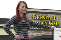 In this March 25, 2020 photo, Courtney Keith poses for a photo in front of Glendale Garden Café in Toledo, Ohio. Keith, who has spent four years in drug and alcohol addiction recovery, lost her job as a waitress there when Ohio banned sit-down dining to combat the coronavirus. "I haven't had any thoughts about using, but everybody is different. What if this does lead to a mass relapse?" she said. (AP Photo/John Seewer)