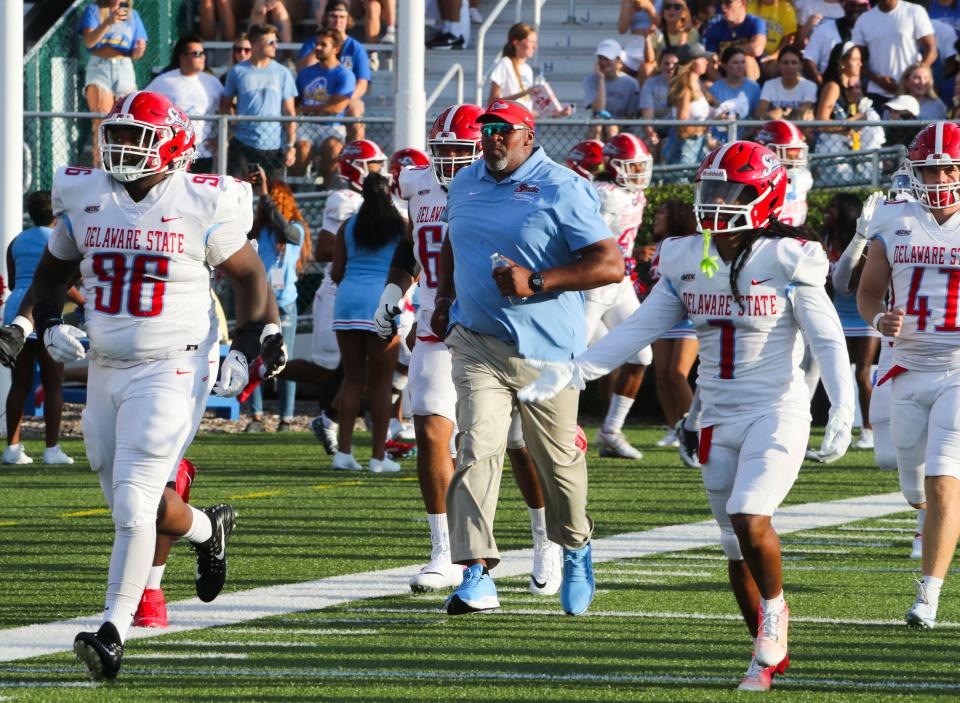 Delaware State head coach Rod Milstead enters with his team before Delaware's 35-9 win against Delaware State at Delaware Stadium, Saturday, Sept. 10, 2022.