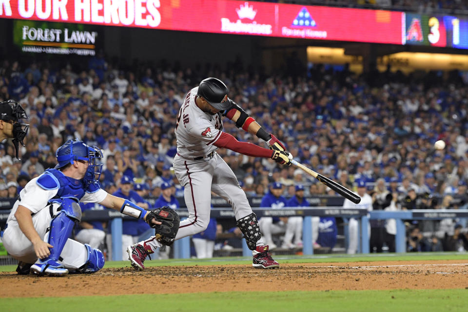 Arizona Diamondbacks' Lourdes Gurriel Jr. hits a solo home run during the sixth inning in Game 2 of a baseball NL Division Series against the Los Angeles Dodgers, Monday, Oct. 9, 2023, in Los Angeles. (AP Photo/Mark J. Terrill)