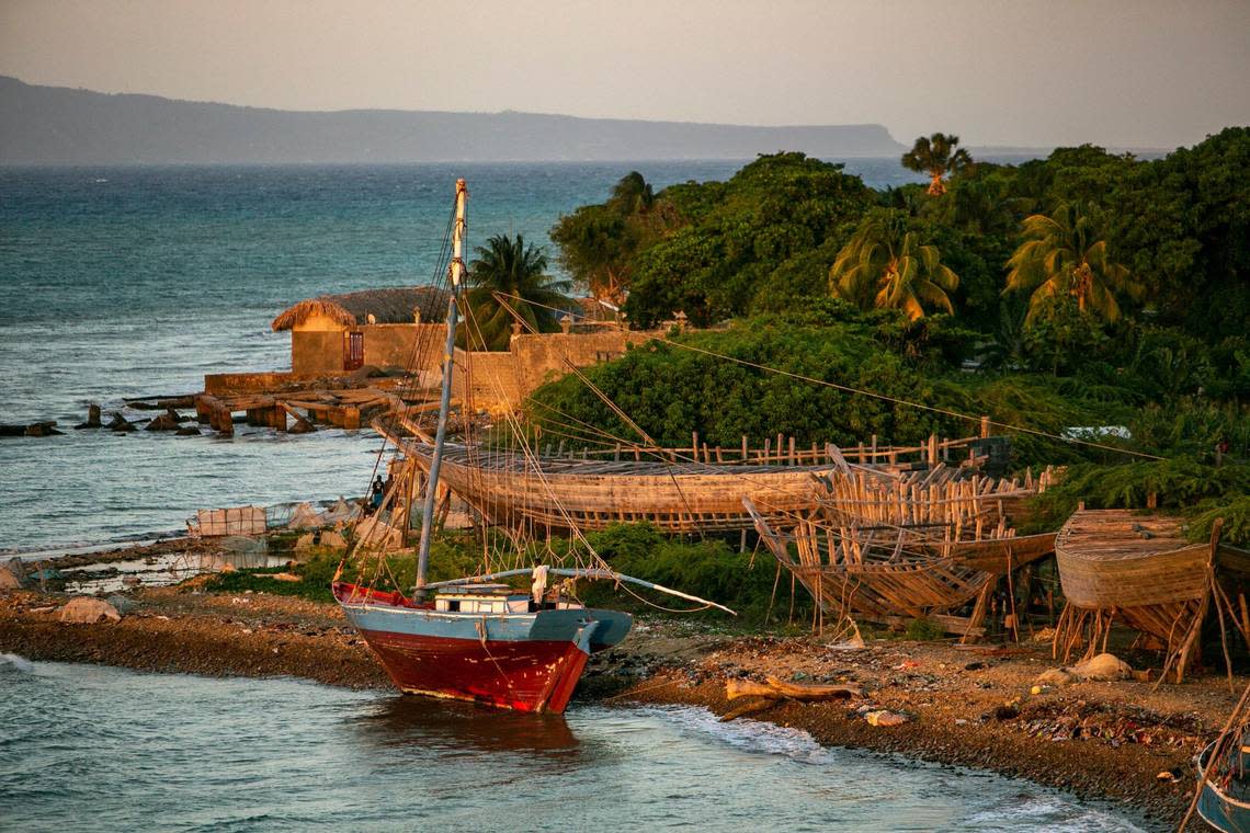 Various wooden sailboats in different stages of construction and repair line the bay on March 24, 2022, in Bodin on the outskirts of Port-de-Paix, Haiti.