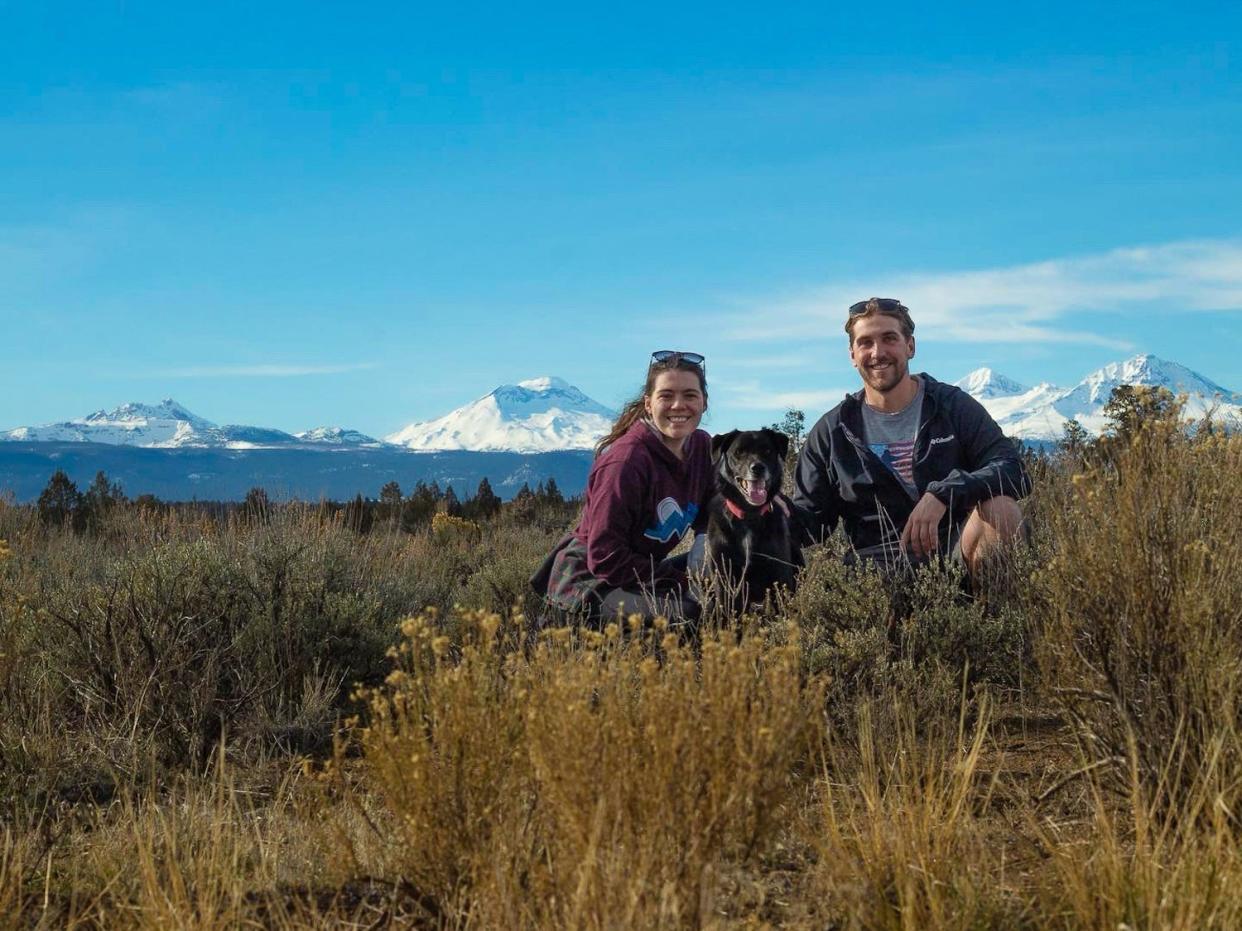 The couple on a walk with a dog.