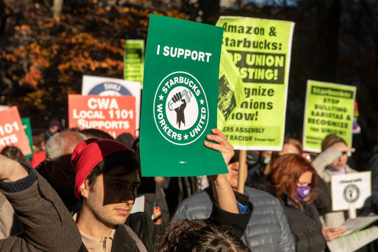 <span>Starbucks workers and their supporters rally outside city hall in New York in December.</span><span>Photograph: Sarah Yenesel/EPA</span>