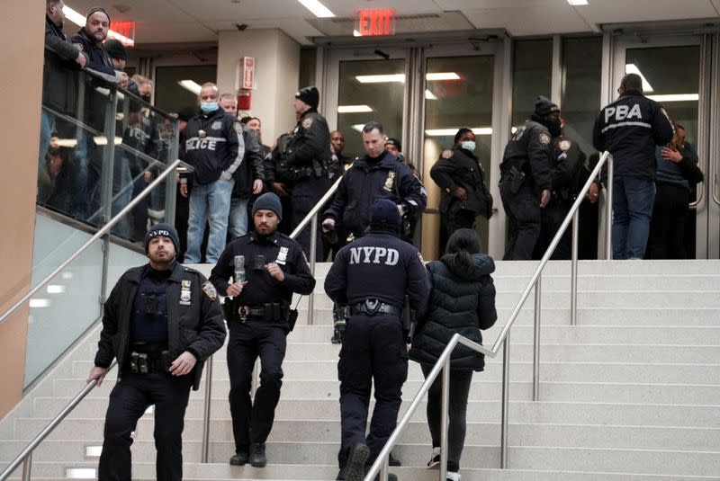 Emergency personnel respond at the scene where NYPD officers were shot while responding to a domestic violence call