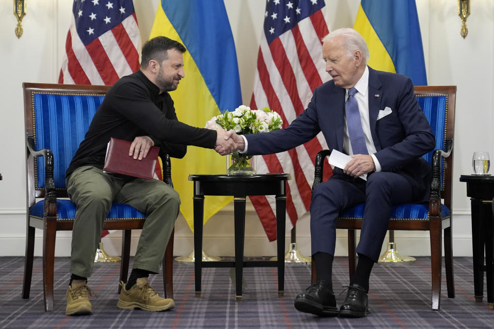 U.S. President Joe Biden shakes hands with Ukrainian President Volodymyr Zelenskyy in Paris, Friday, June 7, 2024. (AP Photo/Evan Vucci)