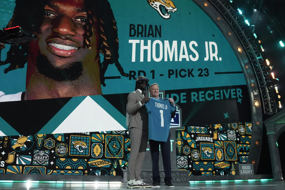 LSU wide receiver Brian Thomas Jr. poses with NFL Commissioner Roger Goodell after being chosen by the Jacksonville Jaguars with the 23rd overall pick during the first round of the NFL football draft, Thursday, April 25, 2024, in Detroit. (AP Photo/Jeff Roberson)