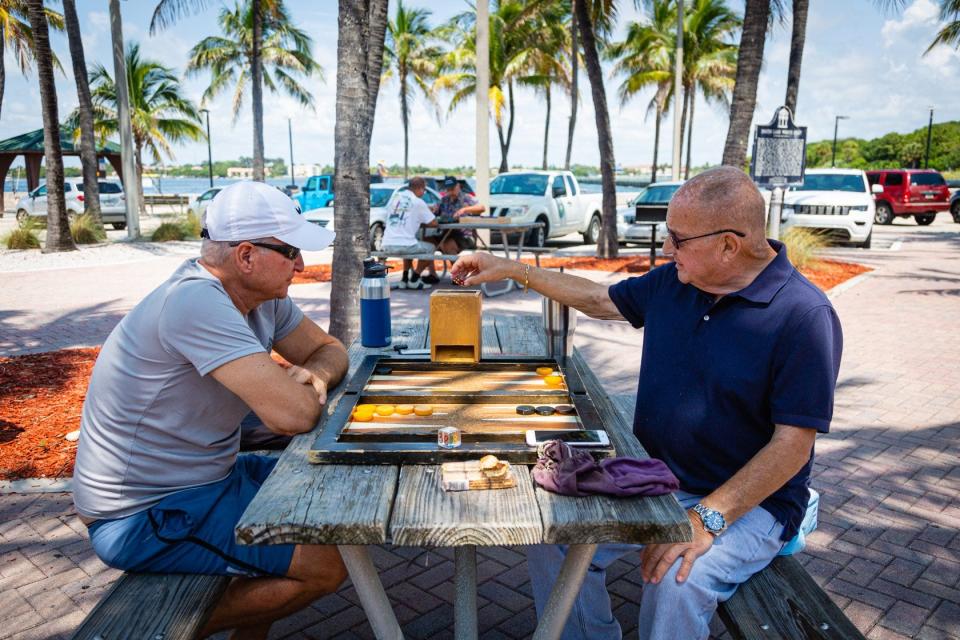 Jimmy Pregot of Atlantis and James Macdonald from Lake Worth play backgammon in the shade of the pavilion at Ocean Inlet Park in Boynton Beach. 