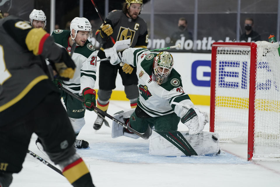 Vegas Golden Knights left wing Max Pacioretty, left, scores on Minnesota Wild goaltender Cam Talbot (33) during the second period of an NHL hockey game Monday, March 1, 2021, in Las Vegas. (AP Photo/John Locher)