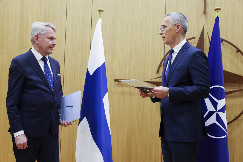 Finnish Foreign Minister Pekka Haavisto, left, speaks with NATO Secretary-General Jens Stoltenberg prior to handing over his nation's accession document during a meeting of NATO foreign ministers at NATO headquarters in Brussels, Tuesday, April 4, 2023. Finland joined the NATO military alliance on Tuesday, dealing a major blow to Russia with a historic realignment of the continent triggered by Moscow's invasion of Ukraine. (Johanna Geron, Pool Photo via AP)