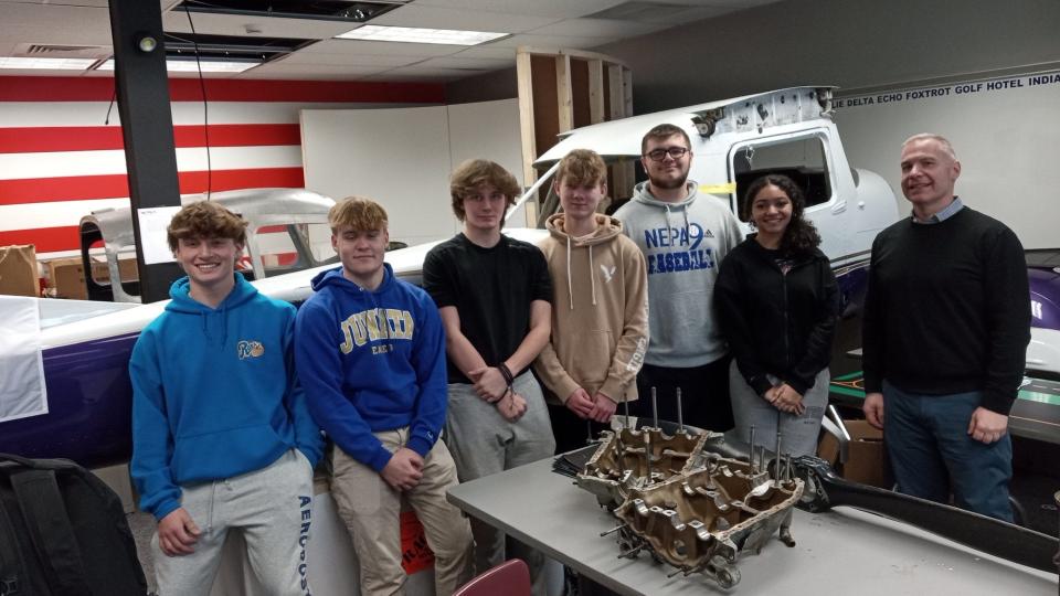 High school students in the Wallenpaupack Aeronautical Science & Aviation (WASA) program stand near the Cessna 150H airplane they are re-assembling in the classroom. From left are Rylan Downey, Grady Hearn, Camron Ortiz, Ben Scholl, Anthony Thaxton, Jaslene Toro and WASA teacher Eric Greenberger.