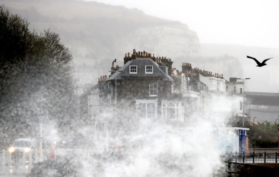 Waves crash over the promenade in Dover, Kent, during strong winds and rain.