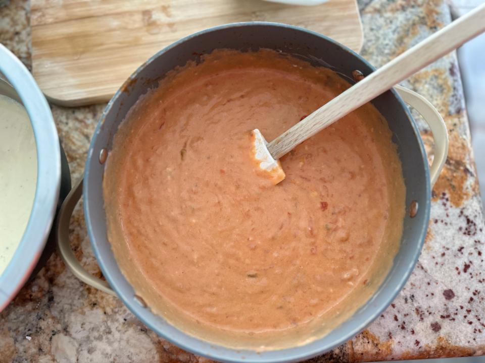 smooth tomato sauce in a pot with a rubber spatula