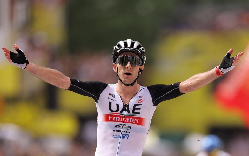 Adam Yates celebrates winning the opening stage and taking the maillot jaune