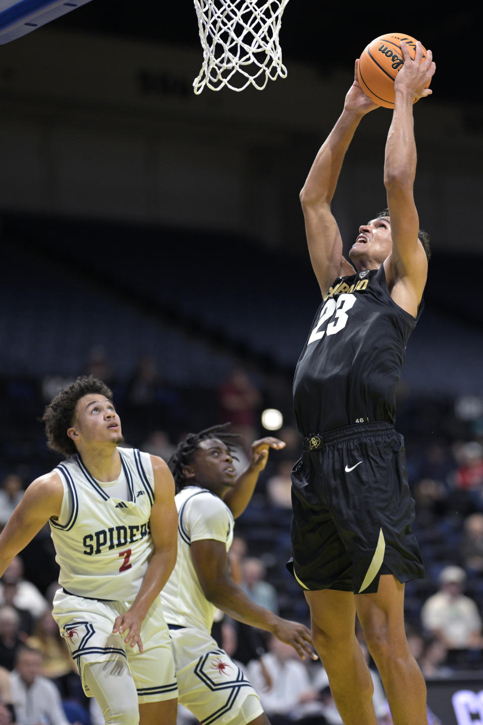 Colorado forward Tristan da Silva (23) goes up for a dunk in front of Richmond guard Jordan King (2) during the second half of an NCAA college basketball game, Monday, Nov. 20, 2023, in Daytona Beach, Fla. (AP Photo/Phelan M. Ebenhack)