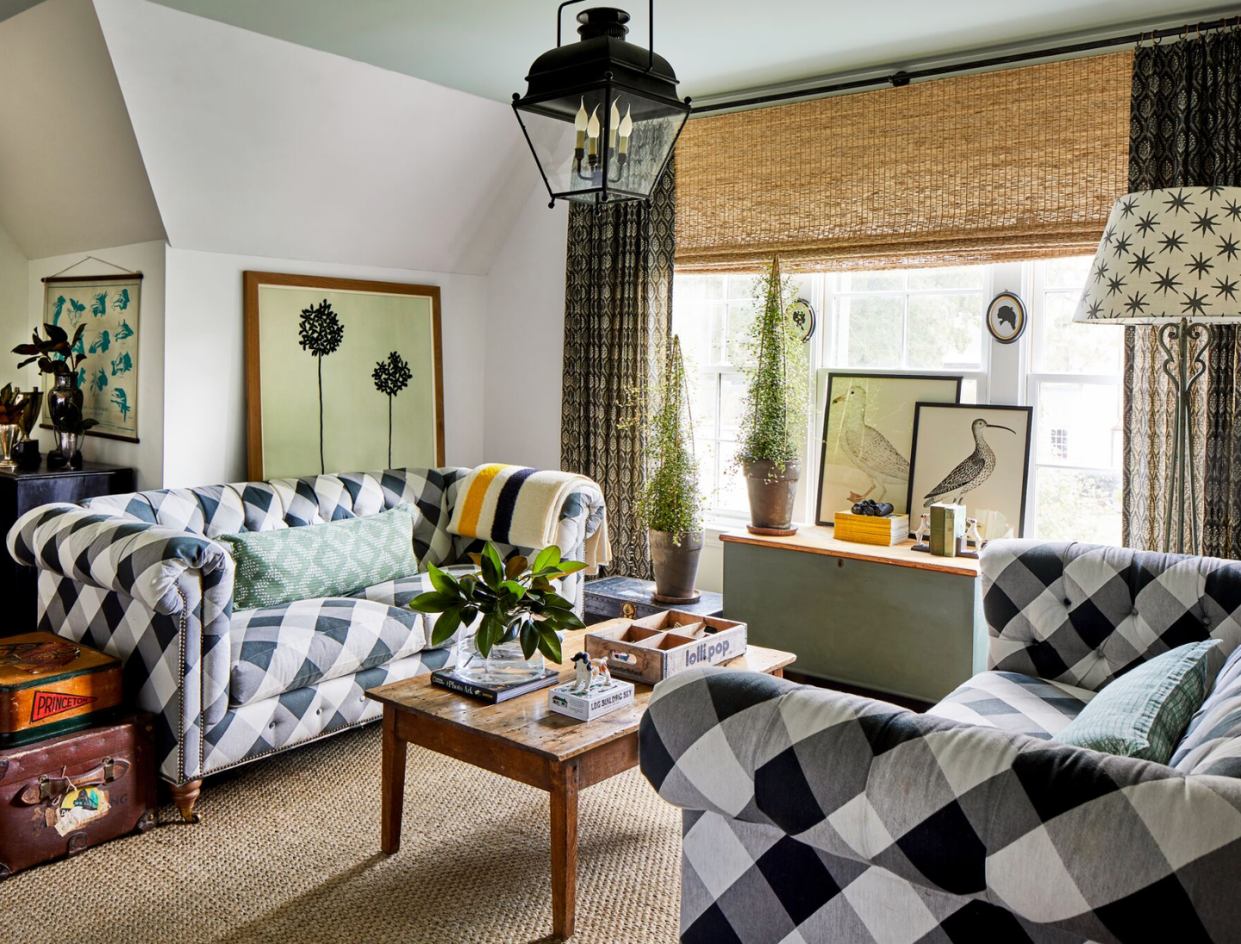 a living room with a black and white checked sofas and a wood coffee table