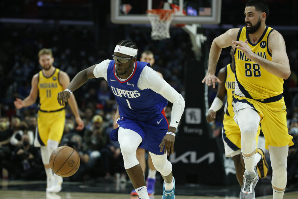 Los Angeles Clippers guard Reggie Jackson (1) and Indiana Pacers center Goga Bitadze (88) chase the ball during the second half of an NBA basketball game in Los Angeles, Monday, Jan. 17, 2022. (AP Photo/Ringo H.W. Chiu)