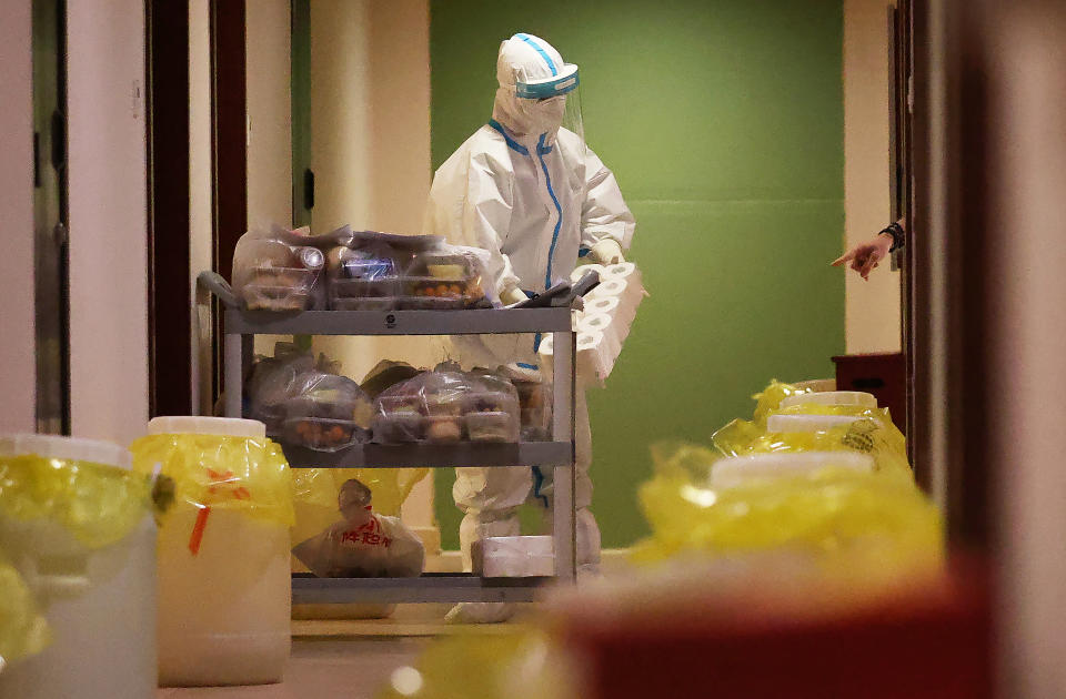 BEIJING, CHINA - FEBRUARY 06: A volunteer is seen dispensing food and water inside the Shuanglong Hotel which is serving as an isolation facility during the Beijing 2022 Winter Olympic Games on February 06, 2022 in Zhangjiakou, China. (Photo by Ian MacNicol/Getty Images)