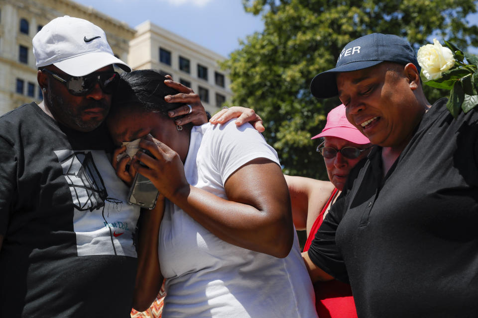 Mourners gather at a vigil following a mass shooting in Dayton, Ohio, on Sunday. (AP Photo/John Minchillo)