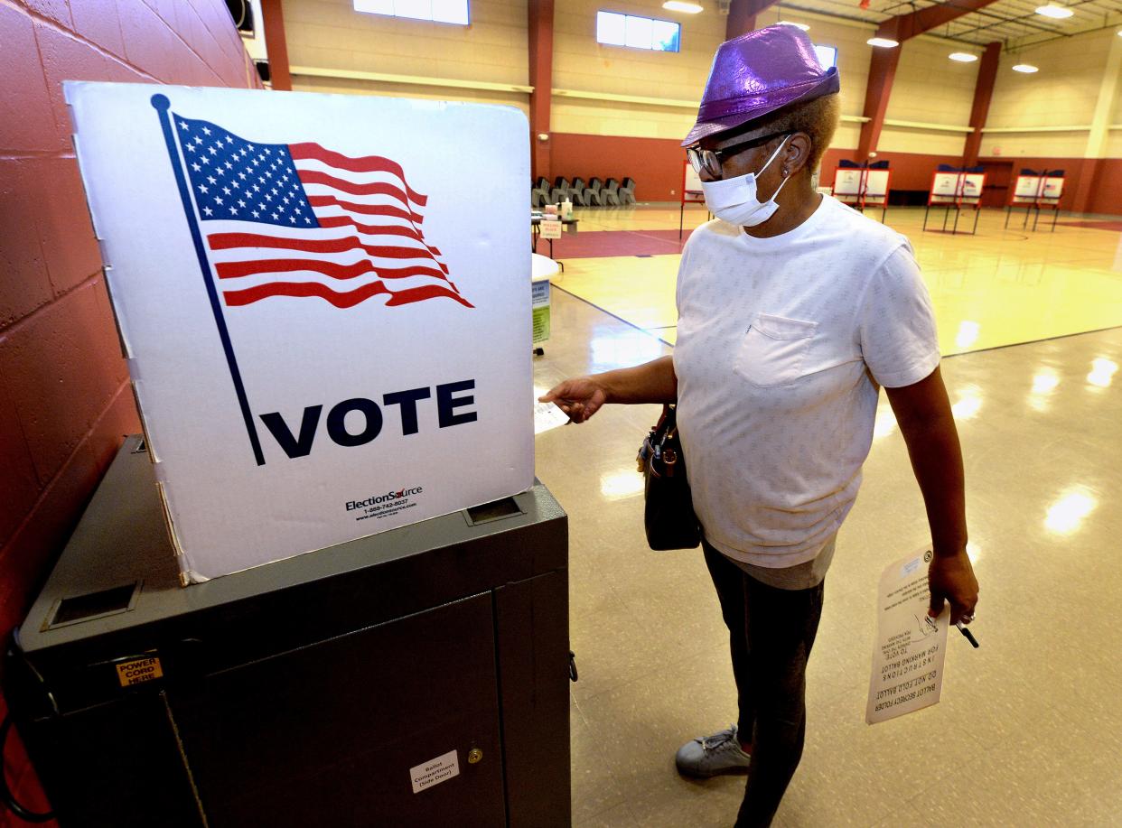 Denise Shields places her ballet in the voting machine at the Union Baptist Church Tuesday June 28, 2022.