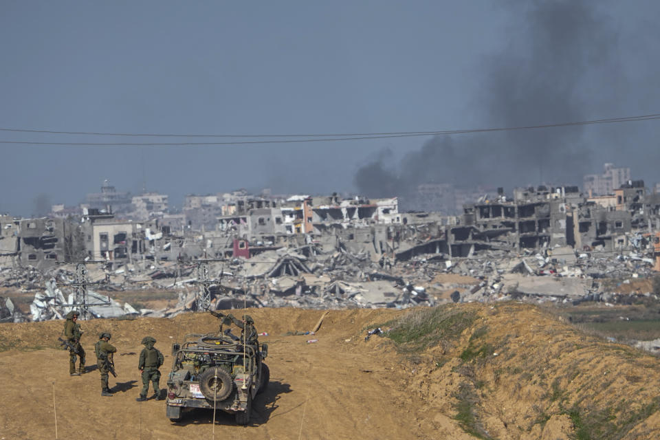 Israeli army troops are seen near the Gaza Strip border, in southern Israel, Sunday, Dec. 24, 2023. The army is battling Palestinian militants across Gaza in the war ignited by Hamas' Oct. 7 attack into Israel. (AP Photo/Ariel Schalit)