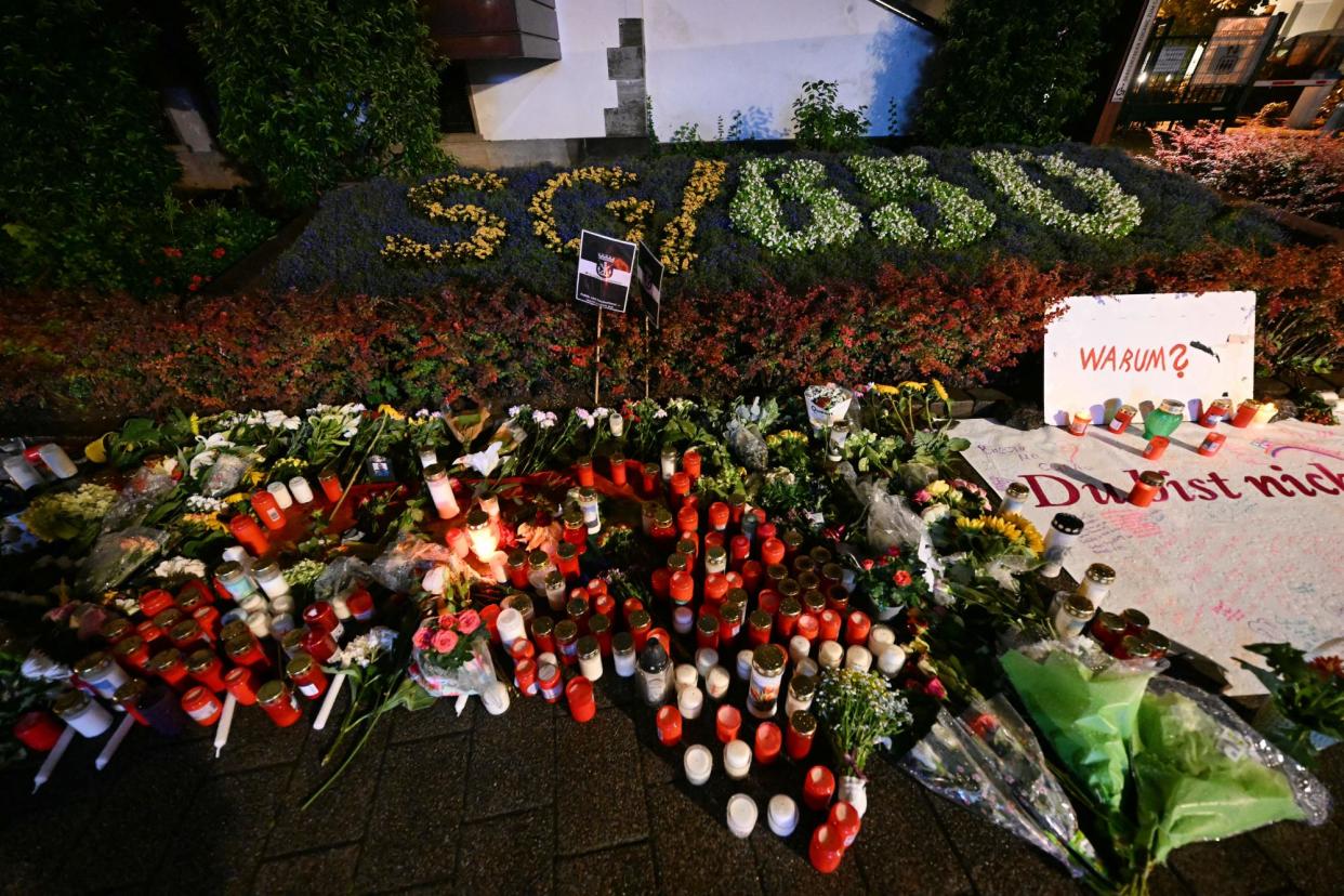 <span>Candles and flowers and the inscription "Why? You are not alone" are pictured on late August 24, 2024 near the area where three people were killed and several injured during a knife attack during a city festival in Solingen, Germany.</span><span>Photograph: Ina Fassbender/AFP/Getty Images</span>