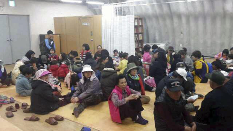 In this photo provided by the Ongjin County, residents of Yeonpyeong Island rest as they evacuate from their homes to a shelter on the island, South Korea, near the West Sea border with North Korea, Monday, March 31, 2014. (AP Photo/The Ongjin County)