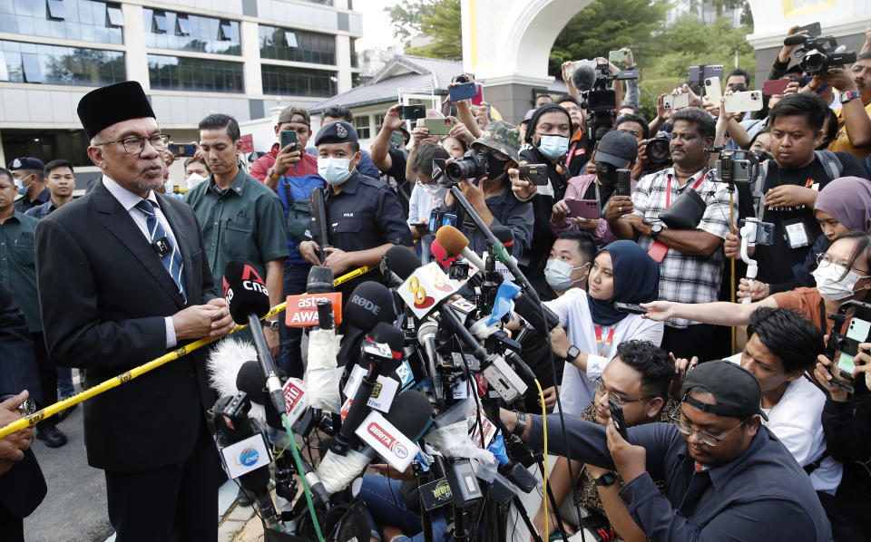 Opposition leader Anwar Ibrahim speaks to media outside the entrance of the National Palace after an audience with the Malaysia's King in Kuala Lumpur, Malaysia, Tuesday, Nov. 22, 2022. Malaysia’s election uncertainty deepened Tuesday after a political bloc refused to support either reformist leader Anwar Ibrahim or rival Malay nationalist Muhyiddin Yassin as prime minister, three days after divisive polls produced no outright winner. (AP Photo/FL Wong)