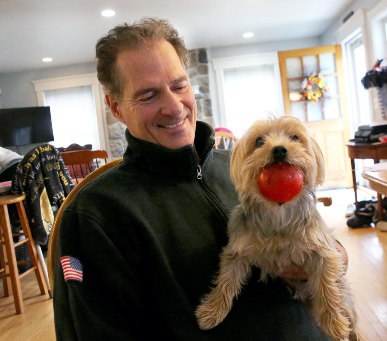 Gracie sits on former U.S. Senator Scott Brown's lap during an interview about his backyard BBQs with presidential candidates, his take on the 2024 NH primary and his plans for the future.