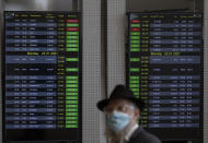 A passenger wears a face mask to protect from coronavirus in the departure hall in Ben Gurion Airport near Tel Aviv, Israel, Sunday, Jan. 24, 2021 during a nationwide lockdown to curb the spread of the virus COVID-19. Prime Minister Benjamin Netanyahu on Sunday said Israel was closing its international airport to nearly all flights as the government races to bring a raging coronavirus outbreak under control. (AP Photo/Ariel Schalit)