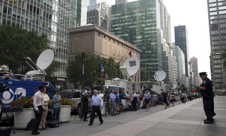 Members of the media wait for New England Patriots quarterback Tom Brady to arrive outside 345 Park Avenue, which houses the National Football League (NFL) headquarters offices, in the Manhattan borough of New York City, June 23, 2015. Brady's appeal of his four-game NFL suspension for participating in a scheme to deflate footballs during last season's playoffs begins Tuesday at NFL headquarters in New York. REUTERS/Mike Segar