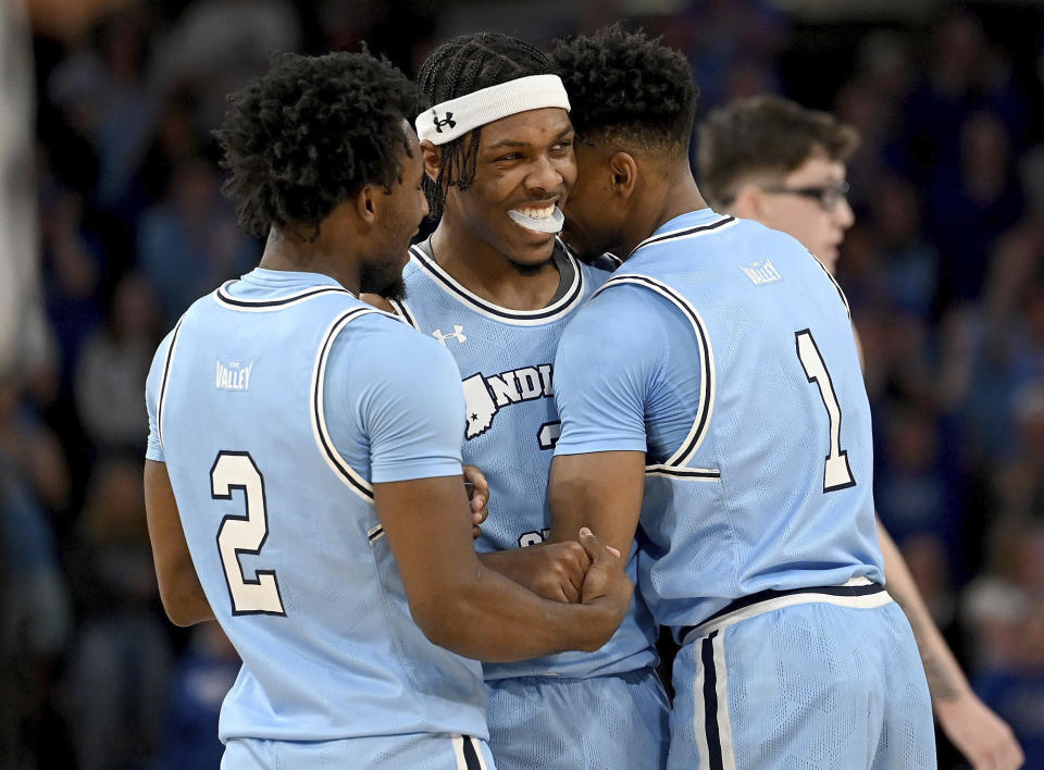 Indiana State's Ryan Conwell, center, is congratulated by teammates Isaiah Swope and Julian Larry during a second-round NCAA college basketball game in the NIT Tournament against Minnesota on Sunday, March 24, 2024, in Terre Haute, Ind. (Joseph C. Garza/The Tribune-Star via AP)