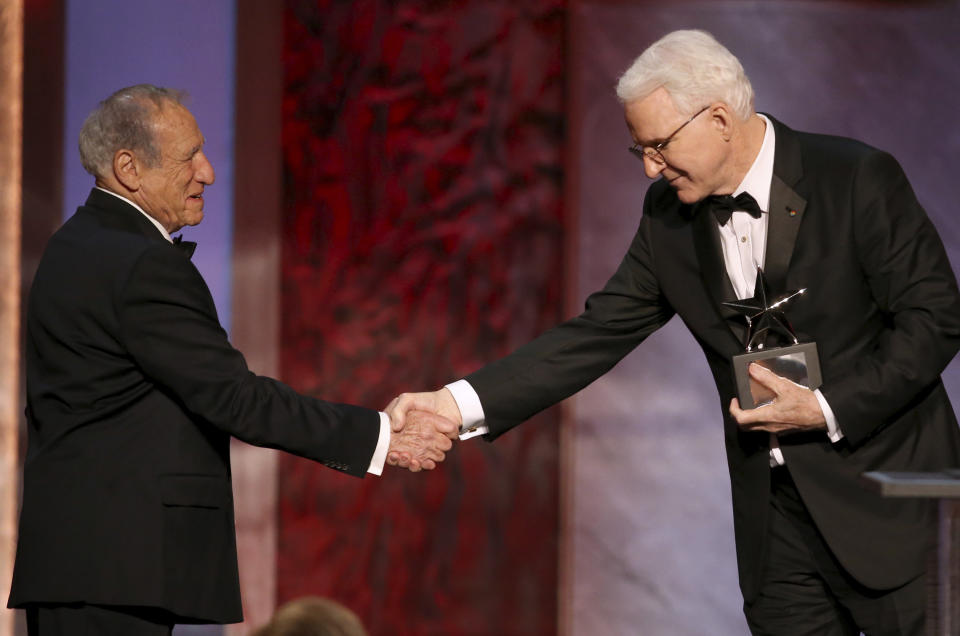 FILE - Mel Brooks, left, presents Honoree Steve Martin with his award at the 43rd AFI Lifetime Achievement Award Tribute Gala at the Dolby Theatre on Thursday, June 4, 2015, in Los Angeles. Martin is the subject of a new documentary "Steve! (Martin) a Documentary in 2 Pieces." (Photo by Paul A. Hebert/Invision/AP, File)