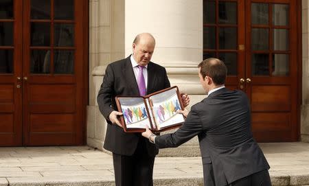 Minister for Finance Michael Noonan prepares to pose for the media on the steps of Leinster House before delivering the 2015 Budget in Dublin October 14, 2014.REUTERS/Cathal McNaughton