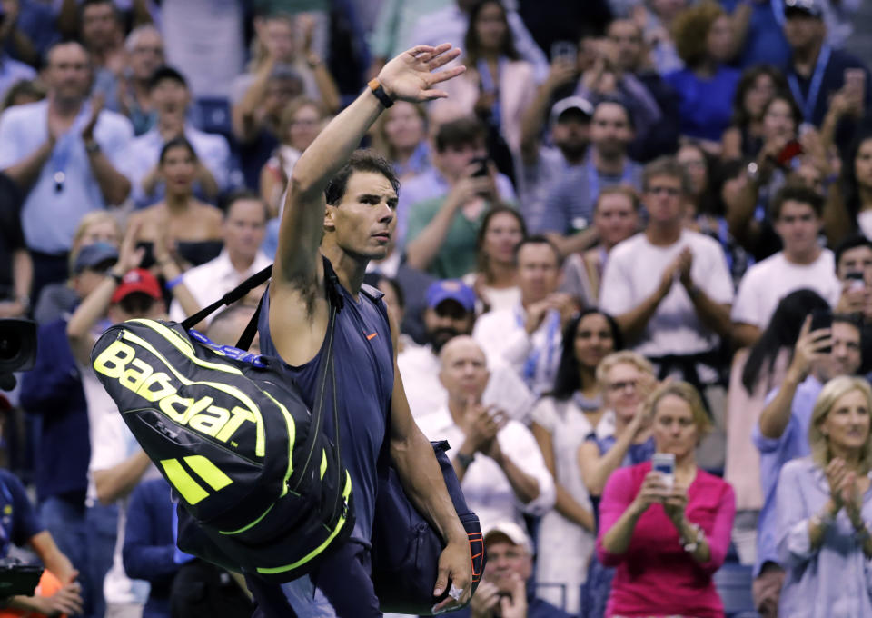 Rafael Nadal, of Spain, waves to fans after retiring from a match against Juan Martin del Potro, of Argentina, during the semifinals of the U.S. Open tennis tournament, Friday, Sept. 7, 2018, in New York. (AP Photo/Seth Wenig)