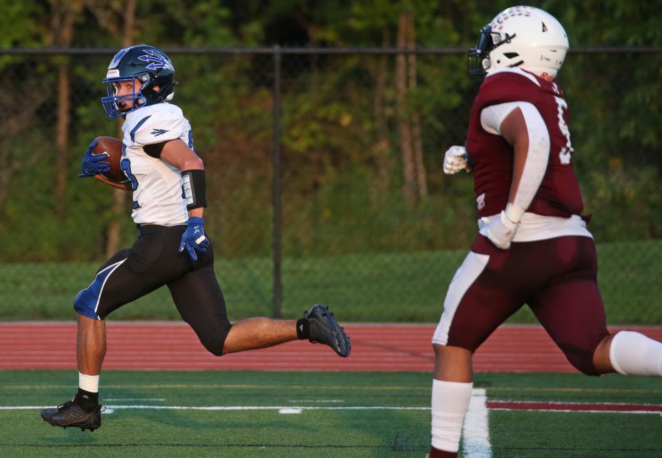 Brockport running back Nathan Parker (32), left, makes a reception across the middle and runs 55 yards to score in the second quarter against Greece Arcadia during their Section V matchup Thursday, Sept. 15, 2022 at Greece Arcadia High School.  Brockport won the game 48-28. 