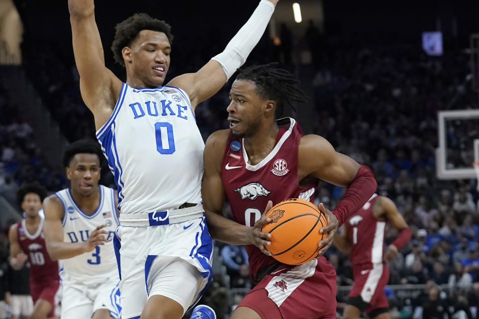 Arkansas guard Stanley Umude, right, drives to the basket against Duke forward Wendell Moore Jr. during the second half of a college basketball game in the Elite 8 round of the NCAA men's tournament in San Francisco, Saturday, March 26, 2022. (AP Photo/Marcio Jose Sanchez)