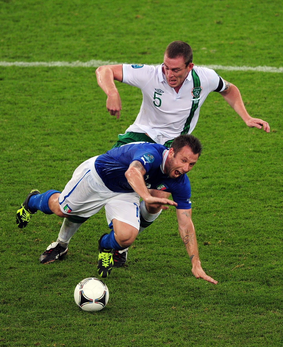 POZNAN, POLAND - JUNE 18: Antonio Cassano of Italy falls under the challenge by Richard Dunne of Republic of Ireland during the UEFA EURO 2012 group C match between Italy and Ireland at The Municipal Stadium on June 18, 2012 in Poznan, Poland. (Photo by Jamie McDonald/Getty Images)