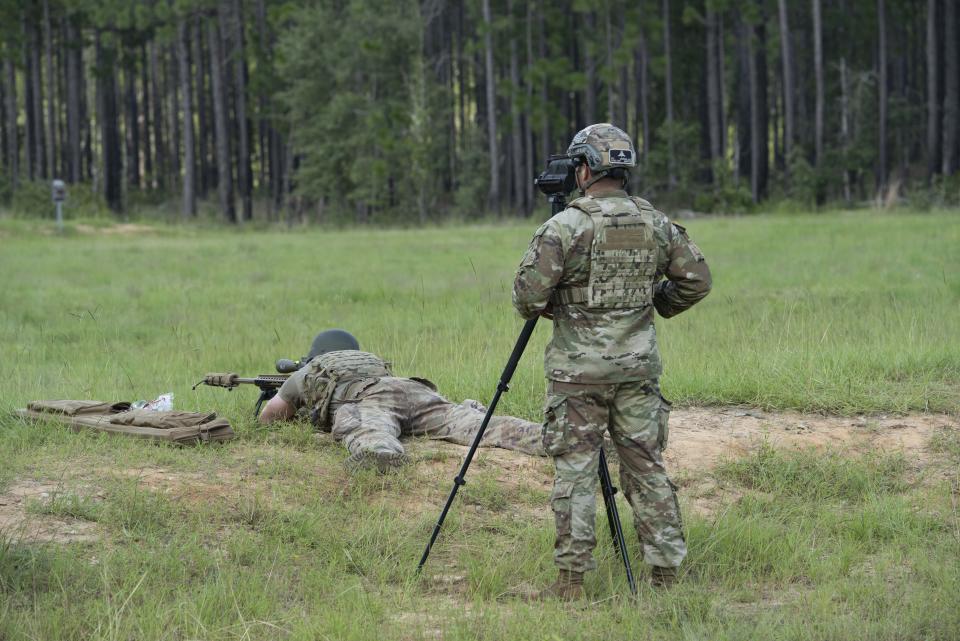 A test NCO assigned to the Airborne and Special Operations Test Directorate observes post-drop live-fire test trials of the MK-22 Precision Sniper Rifle (PSR) at Range 61, Fort Bragg, North Carolina