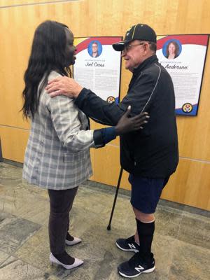 Nyamal Dei, a school board member in Fargo, N.D., is greeted by Vietnam veteran David Halcrow following a special meeting on Thursday, Aug. 18, 2022, to reconsider a decision by the previous board to eliminate reciting the Pledge of Allegiance before meetings. (AP Photo/Dave Kolpack)