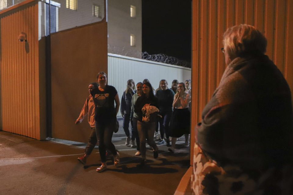 Women walk through a gate after being released from a detention center where protesters were detained during a mass rally following presidential election in Minsk, Belarus, Friday, Aug. 14, 2020. Nearly 7,000 people have been detained and hundreds injured in the clampdown on demonstrators protesting the official results that said Lukashenko won 80% of the vote and his top opposition challenger got only 10%. Police have broken up protests with stun grenades, tear gas, rubber bullets and severe beatings. (AP Photo)