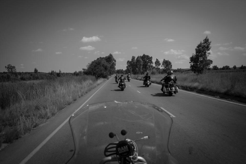 Members of the Midvaal chapter of the CMA ride with other club bikers from their church in Vereeniging to a township church in nearby Sebokeng, Johannesburg (EPA)