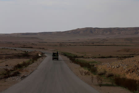 Popular Mobilisation Forces (PMF) fighters ride in a military vehicle near the Iraqi-Syrian border in al-Qaim, Iraq, November 26, 2018. REUTERS/Alaa al-Marjani