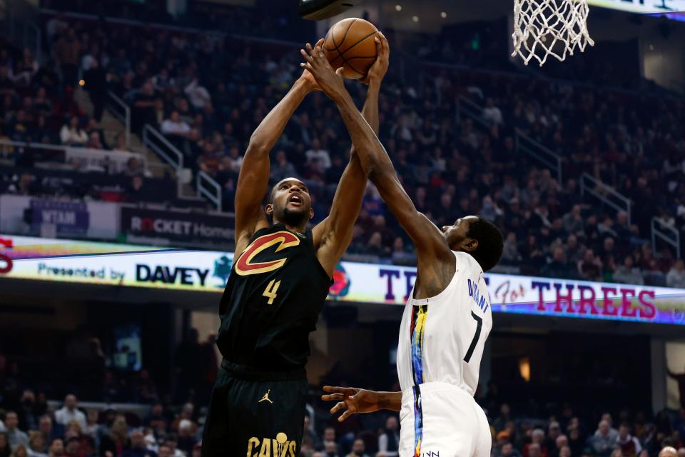 Cavaliers forward Evan Mobley shoots against Brooklyn Nets forward Kevin Durant during the first half, Monday, Dec. 26, 2022, in Cleveland.