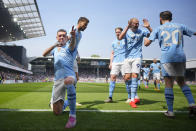 Manchester City's Phil Foden, left, celebrates with teammates after scoring his side's second goal during the English Premier League soccer match between Fulham and Manchester City at the Craven Cottage Stadium in London, Saturday, May 11, 2024. (AP Photo/Kirsty Wigglesworth)