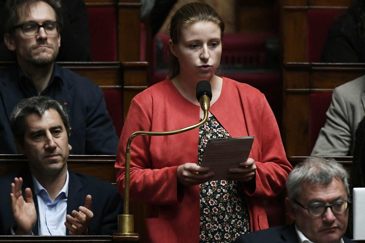 French leftist La France Insoumise (LFI) MP Francois Ruffin (L) applauds French leftist La France Insoumise (LFI) Member of Parliament and member of the left-wing coalition NUPES (Nouvelle Union Populaire Ecologique et Sociale - New People's Ecologic and Social Union) Mathilde Hignet speaking during a session of questions to the government at The National Assembly in Paris on November 29, 2022. (Photo by STEPHANE DE SAKUTIN / AFP)