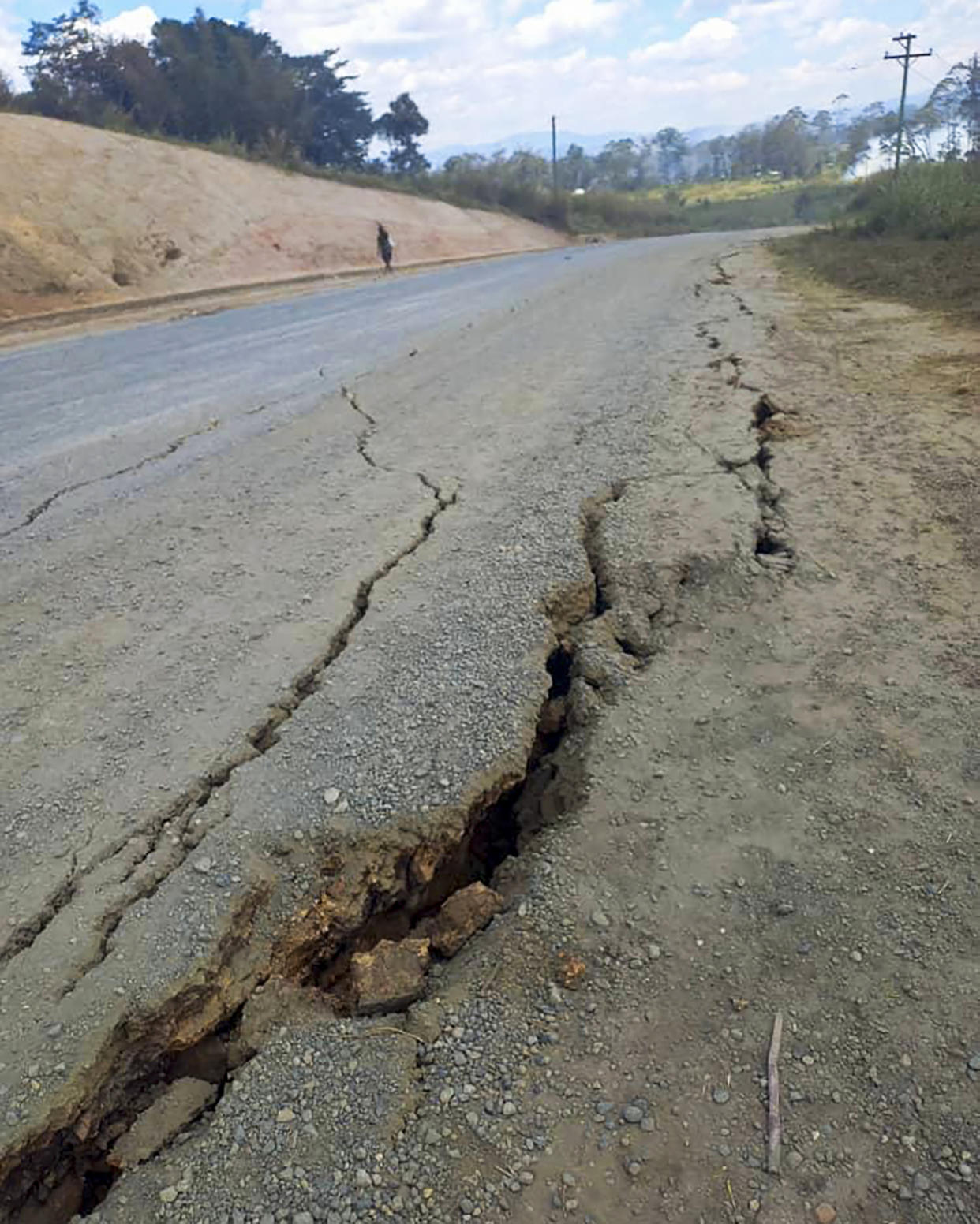 Debris lies strewn across a highway after a landslide near the town of Kainantu, following a 7.6-magnitude earthquake in northeastern Papua New Guinea on Sunday. (Renagi Ravu / via AP)